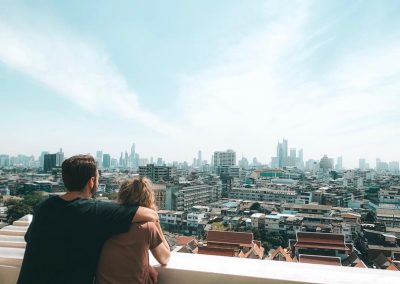 Jake Kramer and his wife take in the Bangkok skyline from a rooftop.