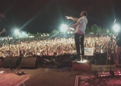 The view from the stage as a festival crowd of thousands cheers under the lights.