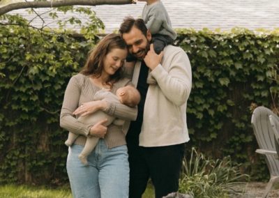 Jake Kramer with his wife, two young sons, and the family dog in their backyard.